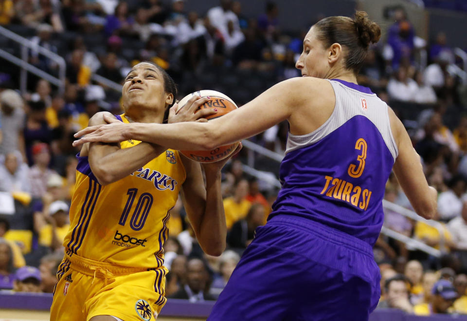 Los Angeles Sparks' Lindsey Harding, left, draws a foul from Phoenix Mercury's Diana Taurasi, right, while heading for the baseket during the first half in Game 1 of their WNBA basketball Western Conference semifinal series on Thursday, Sept. 19, 2013, in Los Angeles. (AP Photo/Danny Moloshok)