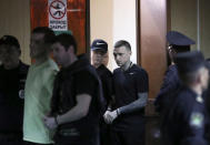 Russian soccer players Pavel Mamayev (R), Alexander Kokorin (2nd L), his brother Kirill Kokorin (2nd R) and acquaintance Alexander Protasovitsky, who are charged with a brutal assault and held in custody, are escorted before a court hearing in Moscow, Russia May 6, 2019. REUTERS/Evgenia Novozhenina