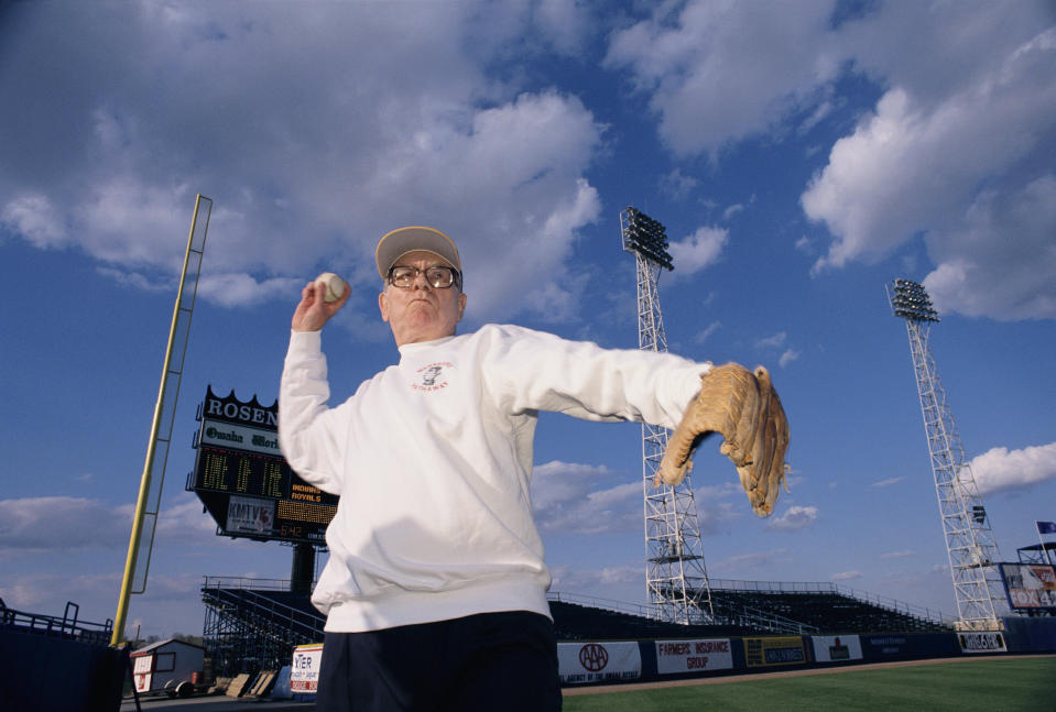 Warren Buffett, CEO of Berkshire Hathaway, pitches a baseball at an Omaha Royals game in Rosenblatt Stadium. Buffett is a part owner of the minor league team. (Photo by mark peterson/Corbis via Getty Images)