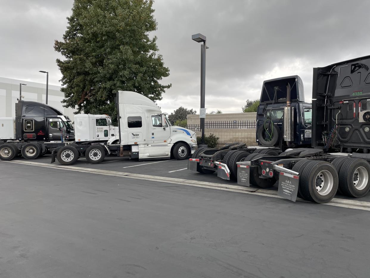 Outside one of California's backlogged ports, trucks await cargo to transport.