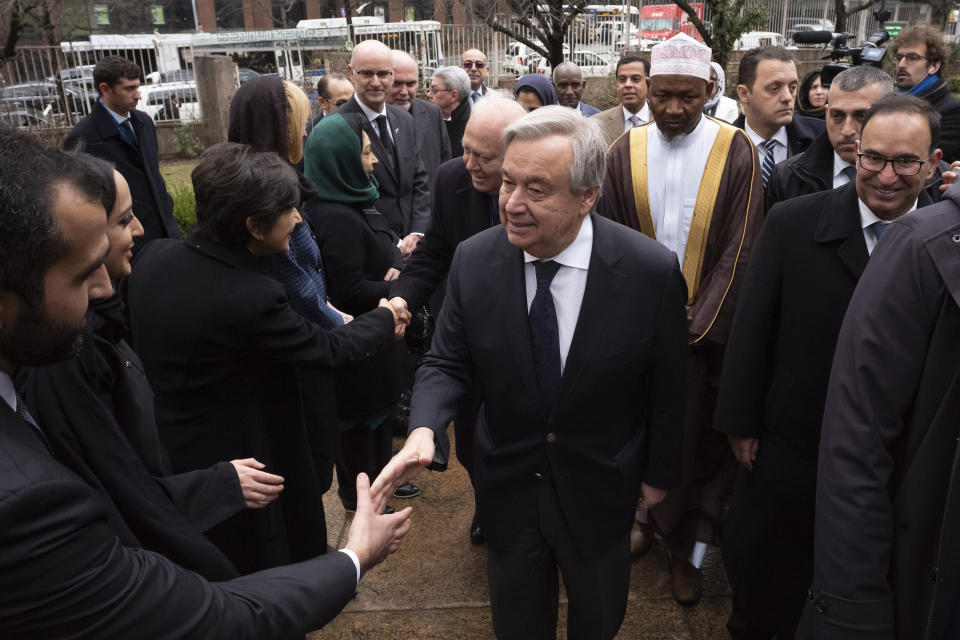 United Nations Secretary General Antonio Guterres, center, is greeted as he arrives for a service at the Islamic Cultural Center of New York, Friday, March 22, 2019 in the wake of a white supremacist's deadly shooting spree on two mosques, March 15, in Christchurch, New Zealand. (AP Photo/Mark Lennihan)