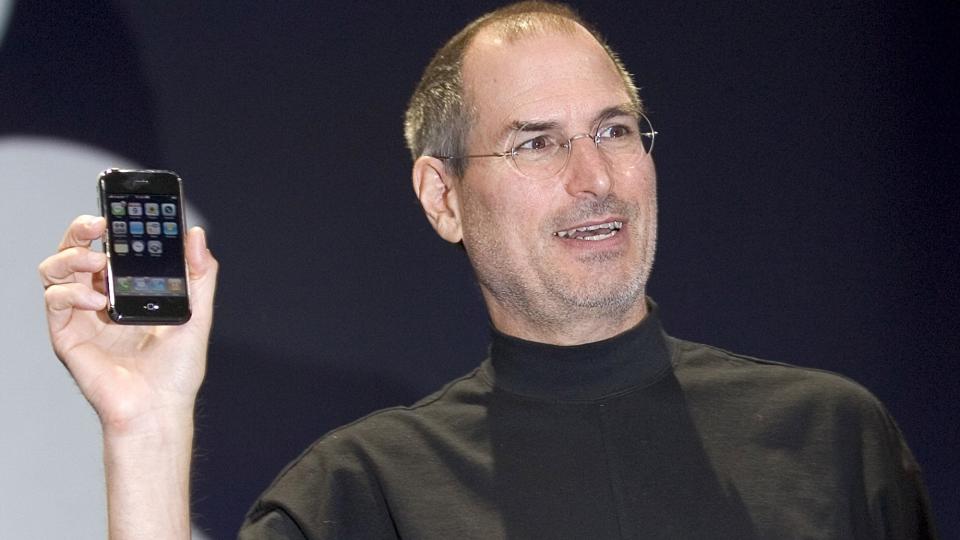 Steve Jobs holding the original iPhone in 2007 at the launch event