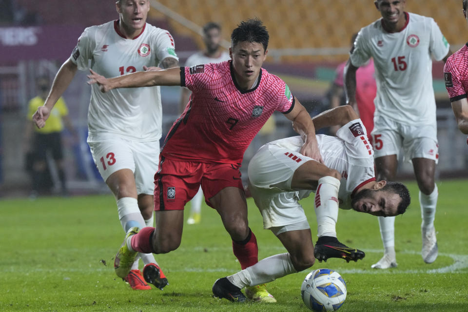 Lebanon's Abbas Assi, right, fights for the ball with South Korea's Cho Gue-sung during the final round of the Asian zone group A qualifying soccer match for the FIFA World Cup Qatar 2022 at Suwon World Cup stadium in Suwon, South Korea, Tuesday, Sept. 7, 2021. (AP Photo/Ahn Young-joon)