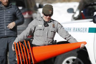 <p>Park Ranger Amy Fink carries cones to use in the Bear Lake trailhead in Rocky Mountain National Park, Saturday, Jan. 20, 2018, in Estes Park, Colo. Despite a government shutdown, Rocky Mountain National Park in Colorado and Yosemite National Park in California were open, but few Park Service staff were available to help visitors. (Photo: David Zalubowski/AP) </p>