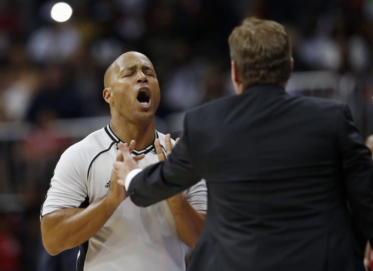 Referee Marc Davis clarifies that the calls will all be made right the next day. (AP Photo/ John Bazemore)
