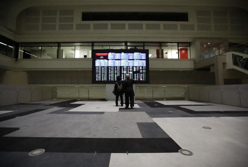 FILE PHOTO - Visitors looks at an electronic board showing the Japan's Nikkei average at the Tokyo Stock Exchange (TSE) in Tokyo, Japan, February 9, 2016. REUTERS/Issei Kato/Files