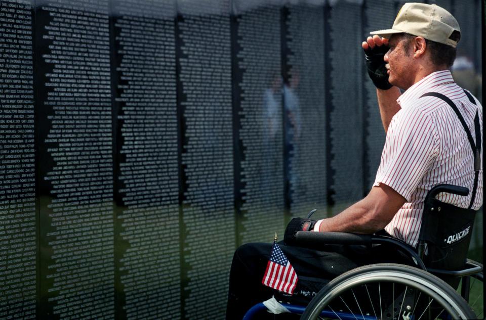 Darron Hardaway of Chattanooga salutes his fallen comrades who died at Vietnam while visiting the travelling version of Washington's Vietnam Veteran's Memorial on the campus of Middle Tennessee State University in Murfreesboro Sept. 13, 2001. Hardaway, who joined the 1st and 35th Field Artillery Unit in 1977, became paralyzed during a training exercise in 1978.