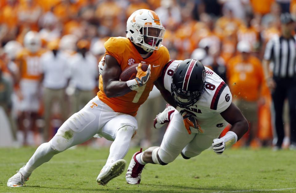 Tennessee running back John Kelly (4) runs for yardage as he’s hit by South Carolina defensive lineman D.J. Wonnum (8) in the first half of an NCAA college football game Saturday, Oct. 14, 2017, in Knoxville, Tenn. (AP Photo/Wade Payne)