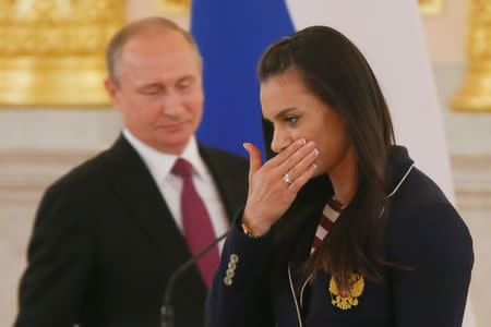 Track-and-field athlete Yelena Isinbayeva reacts as she walks past Russian President Vladimir Putin during his personal send-off for members of the Russian Olympic team at the Kremlin in Moscow, Russia, July 27, 2016. REUTERS/Maxim Shemetov