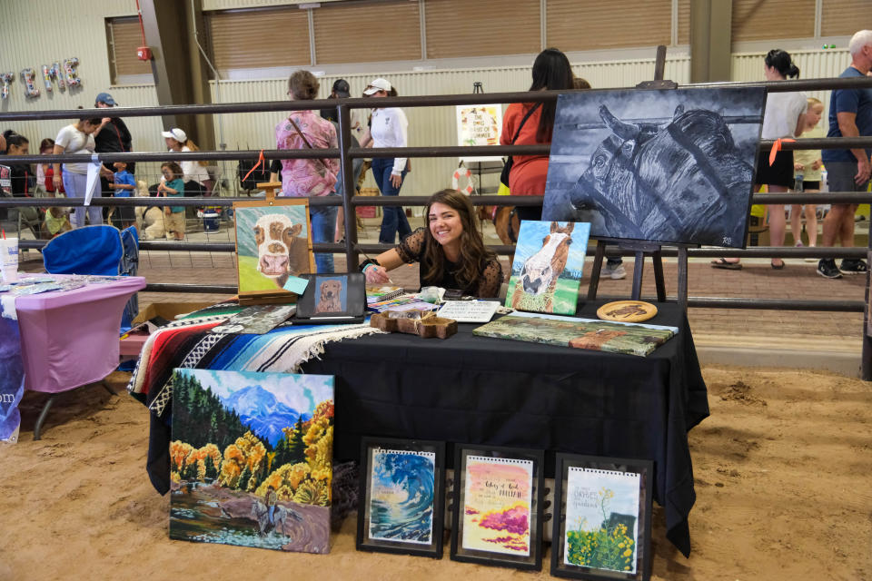 Veterinary student and artist Rachel Jones shows off her work at the Texas Tech University School of Veterinary Medicine's "Barks and Recreation" event Saturday at Mariposa Station in west Amarillo.