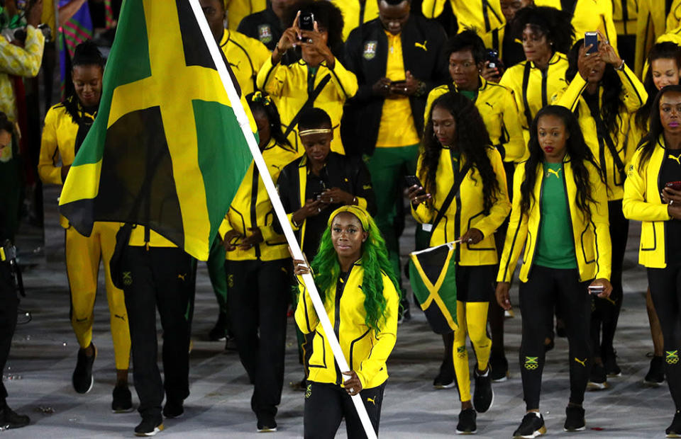 <p>Usain Bolt wasn’t there, but Jamaica’s flag bearer, Shelly-Ann Fraser-Pryce, brought the showmanship. (Photo by Paul Gilham/Getty Images) </p>