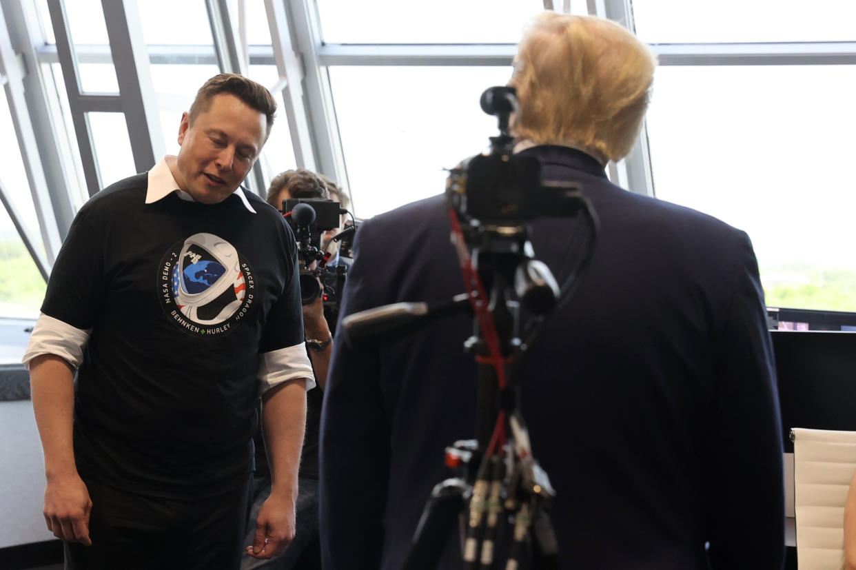 Elon Musk gives a small bow of the head as U.S. President Donald Trump congratulates him at the Firing Room Four after the launch of a SpaceX Falcon 9 rocket and Crew Dragon spacecraft on NASA's SpaceX Demo-2 mission to the International Space Station from NASA's Kennedy Space Center in Cape Canaveral, Florida, U.S. May 30, 2020. REUTERS/Jonathan Ernst