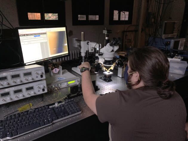 Kevin O’Malley, senior research scientist at NLM Photonics, works at a probe station that measures electro-optic activity in hybridized chips featuring the company’s proprietary materials. (NLM Photonics Photo)