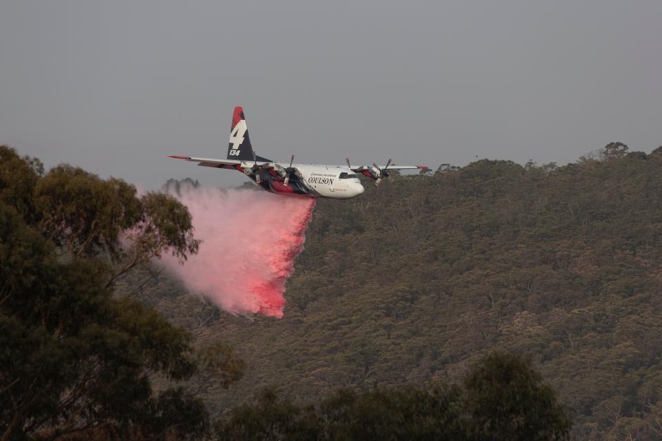 A large air tanker drops retardant near a property on January 10, 2020 in Penrose, Australia. (Brook Mitchell via Getty Images)