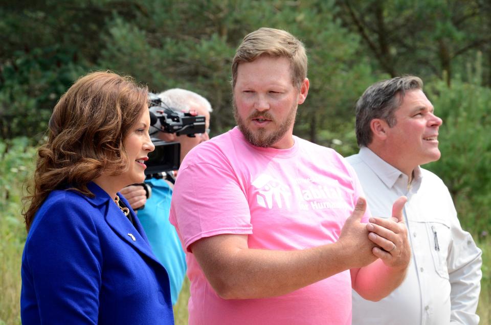 James Dawley (right), director of construction for Northwest Michigan Habitat for Humanity, explains the modular home construction process to Gov. Gretchen Whitmer as they tour the Meadowlands project on Tuesday, Aug. 1, 2023.