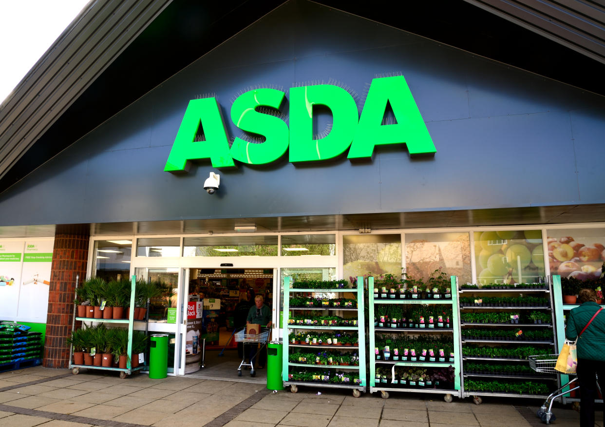 Waterlooville, UK - May 2, 2018: Asda Stores Ltd. trading as Asda, is a British supermarket retailer. The logo is prominent above the glass fronted store-front. 
Advertising, products and Sshoppers are all visible.