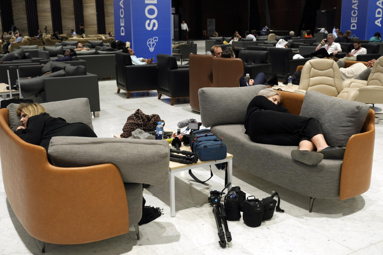 Members of the media rest ahead of a closing plenary session at the COP27 U.N. Climate Summit, Sunday, Nov. 20, 2022, in Sharm el-Sheikh, Egypt. (AP Photo/Peter Dejong)