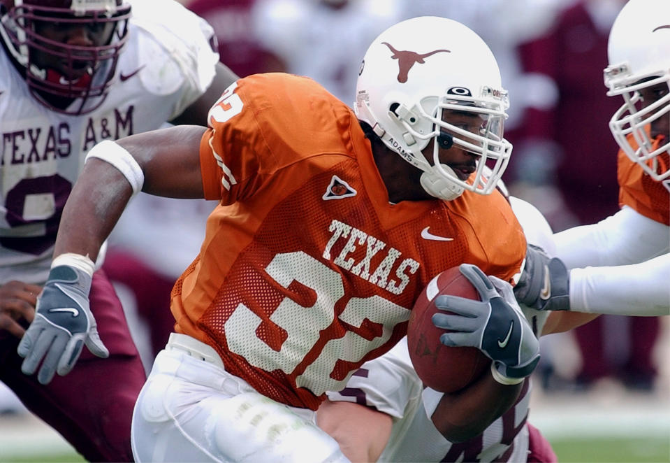 Texas running back Cedric Benson rushes for a three-yard gain during second quarter action against Texas A&M on Friday, Nov. 29, 2002, in Austin, Texas. (AP Photo/Harry Cabluck)