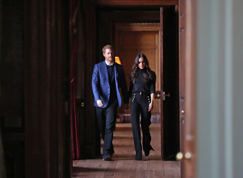 EDINBURGH, SCOTLAND - FEBRUARY 13:  Prince Harry and Meghan Markle walk through the corridors of the Palace of Holyroodhouse on their way to a reception for young people at the Palace on February 13, 2018 in Edinburgh, Scotland.  (Photo by Andrew Milligan - WPA Pool/Getty Images)