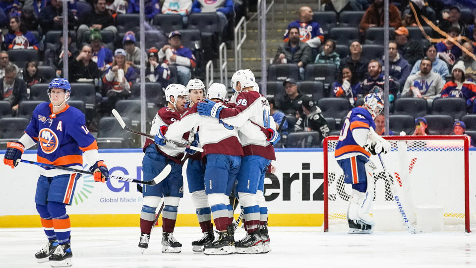 Colorado Avalanche players celebrate after a goal by teammate Evan Rodrigues during the second period of an NHL hockey game against the New York Islanders, Saturday, Oct. 29, 2022, in Elmont, N.Y. (AP Photo/Eduardo Munoz Alvarez)