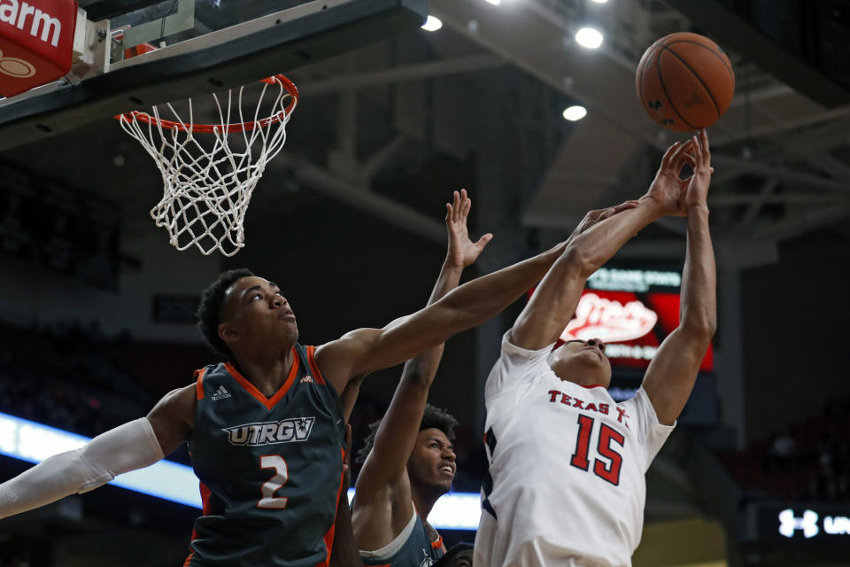 Texas-Rio Grande Valley's Quinton Johnson II (2) knocks the rebound away from Texas Tech's Kevin McCullar (15) during the second half of an NCAA college basketball game Saturday, Dec. 21, 2019, in Lubbock, Texas. (AP Photo/Brad Tollefson)