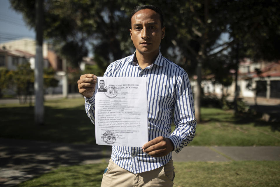 Diego Fernando Espitia, the cousin of Colombian soldier Oscar Arley Triana, who disappeared in the war in Ukraine, shows his cousin's entry papers into the Ukrainian army, in Bogotá, Colombia, Wednesday, Jan. 10, 2024. Espitia lost contact with his cousin, who joined the Ukrainian army in August 2023. Six weeks later, the retired soldier from Bogotá stopped posting updates on social media. The Ukrainian military unit where Triana was serving confirmed to AP that Triana is officially missing but would not disclose any details surrounding the circumstances in which he disappeared. (AP Photo/Ivan Valencia)