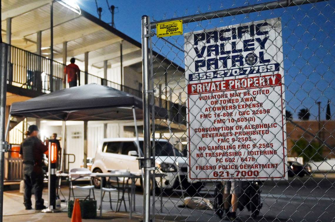 Pacific Valley Patrol security guards maintain a station at Travel Inn & Suites, a former motel turned into Project Homekey housing for the homeless Tuesday, April 5, 2022 in Fresno.