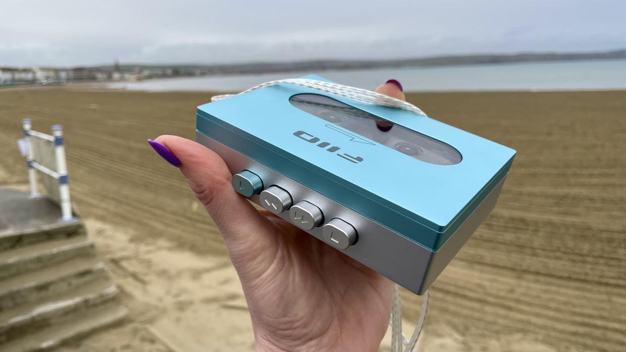  FiiO CP13 in a hand, with a Weymouth seafront backdrop. 