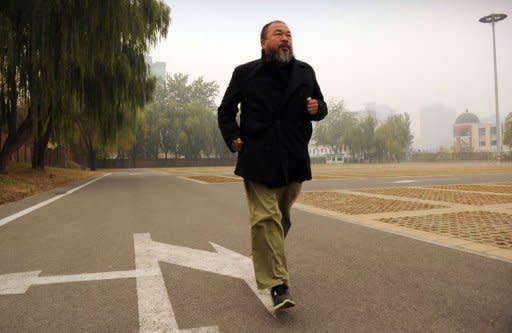 Chinese artist Ai Weiwei exercises in a car park in Beijing on November 16, 2011. Ai has turned the tables on China's Communist regime by transforming a crippling tax fine he says is designed to silence him into a huge wave of solidarity