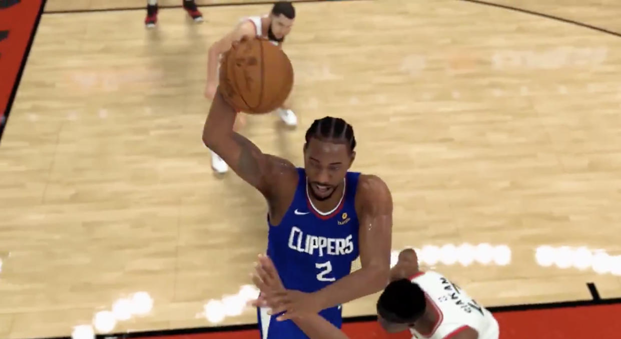 Kawhi Leonard, in his new Los Angeles Clippers jersey, takes it to the rim against the Toronto Raptors during the gameplay trailer for NBA 2K20. (Twitter//@NBA2K)