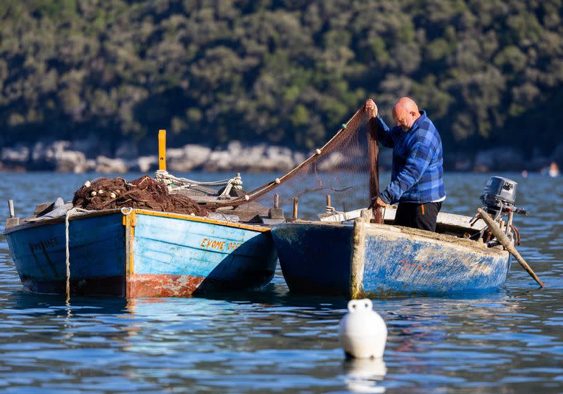 Fisherman Marko Krstic is preparing a fishing net in Molunat