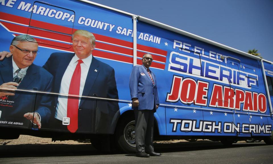 Former Maricopa County Sheriff Joe Arpaio in front of his campaign vehicle during a campaign stop