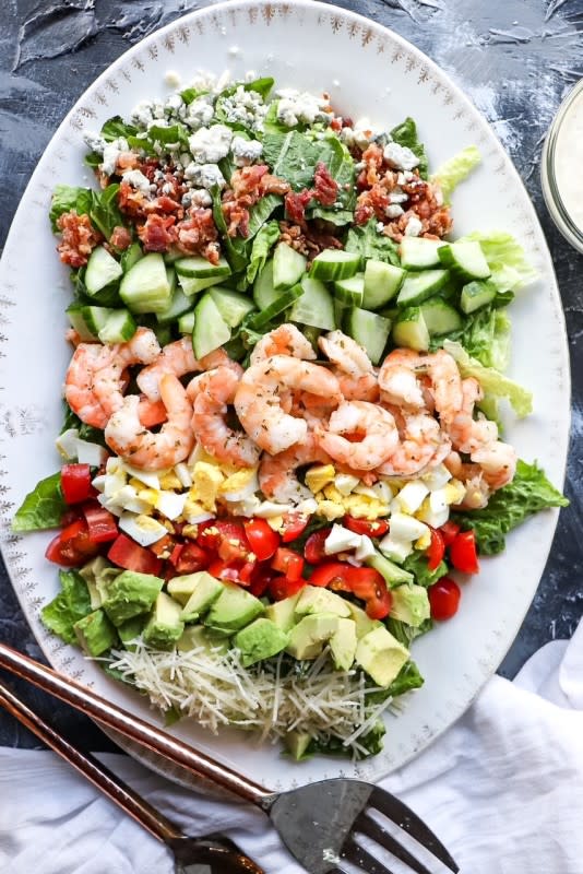 <p>Razzle Dazzle Life</p><p>This Cobb Salad with Cilantro Lime Marinated Shrimp is made with a variety of vegetables, and topped with a succulent shrimp marinated with cilantro and lime. It is the perfect side dish, or hearty enough to be a stand-alone meal!</p><p><strong>Get the Recipe:</strong><a href="https://www.razzledazzlelife.com/cobb-salad-with-shrimp/" rel="nofollow noopener" target="_blank" data-ylk="slk:Shrimp Cobb Salad;elm:context_link;itc:0;sec:content-canvas" class="link rapid-noclick-resp"><strong> Shrimp Cobb Salad</strong></a></p>
