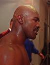 <p>Evander Holyfield walks to his locker room following his fight with Mike Tyson at the MGM Grand Garden in Las Vegas, Saturday, June 28, 1997. Tyson bit Holyfield’s ear twice during the fight and was later disqualified after the third round. Holyfield retained his title. (AP Photo/Jack Dempsey) </p>