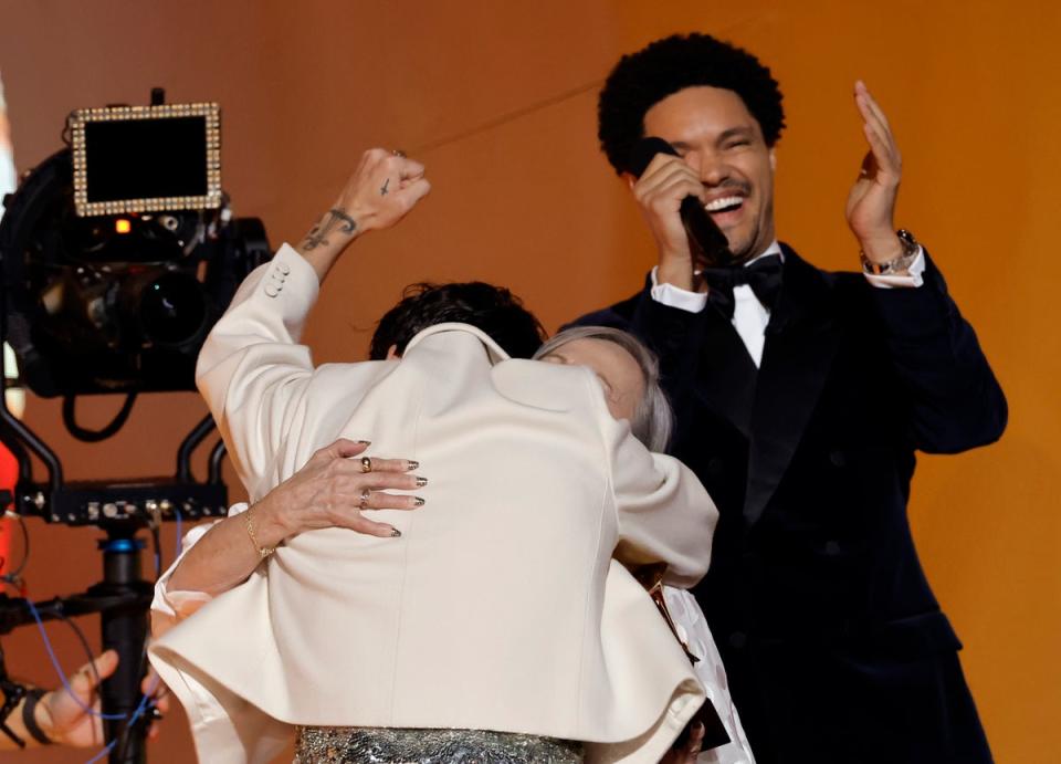 Harry Styles hugs his biggest fan, Reina, while accepting the award for Album of the Year (Getty Images for The Recording A)