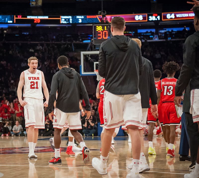 Utah Utes forward Tyler Rawson (21) screams in celebration at his teammates after a time is called following his go ahead three pointer in the fourth as the University of Utah Running Utes take on the Western Kentucky Hilltoppers in the semifinal round of the 2018 NIT in Madison Square Garden in New York City on 