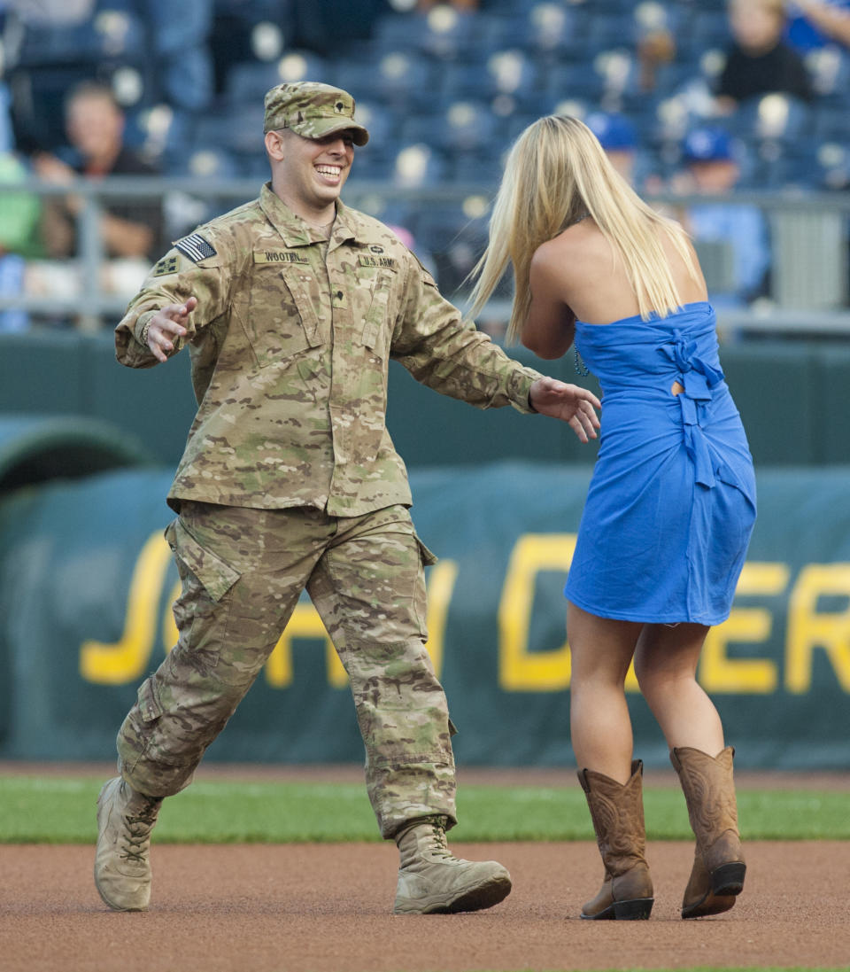 <p>Army Specialist Wes Wooten of Maryville, Missouri returns from Afghanistan to surprise his sister Mataya Wooton before a game between the Los Angeles Angels of Anaheim and the Kansas City Royals at Kauffman Stadium on September 15, 2012 in Kansas City, Missouri. (Photo by Tim Umphrey/Getty Images) </p>