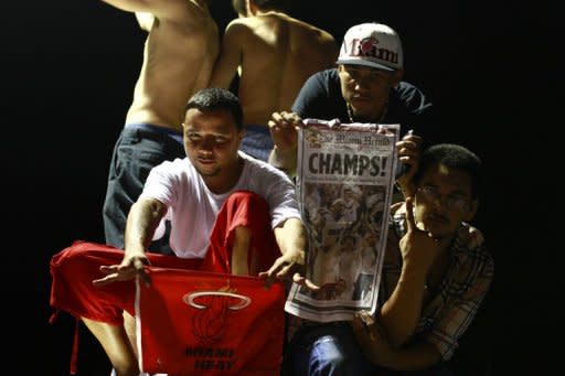 Fans celebrate the Miami Heat's victory over the Oklahoma City Thunder during the 2012 NBA finals in Miami, Florida