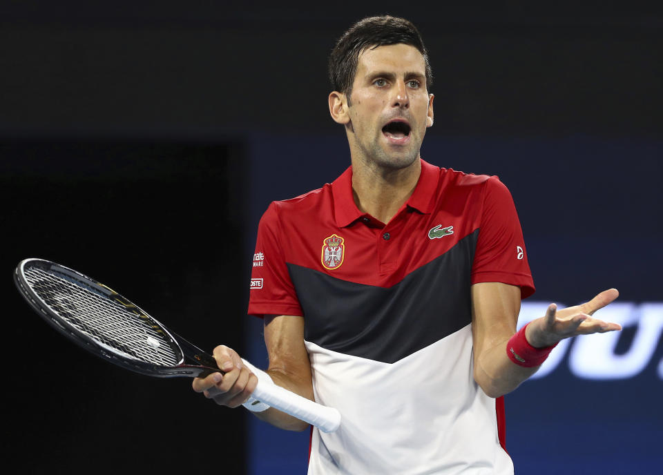 Novak Djokovic of Serbia reacts after being heckled by a spectator during his match against Kevin Anderson of South Africa at the ATP Cup tennis tournament in Brisbane, Australia, Saturday, Jan. 4, 2020. (AP Photo/Tertius Pickard)