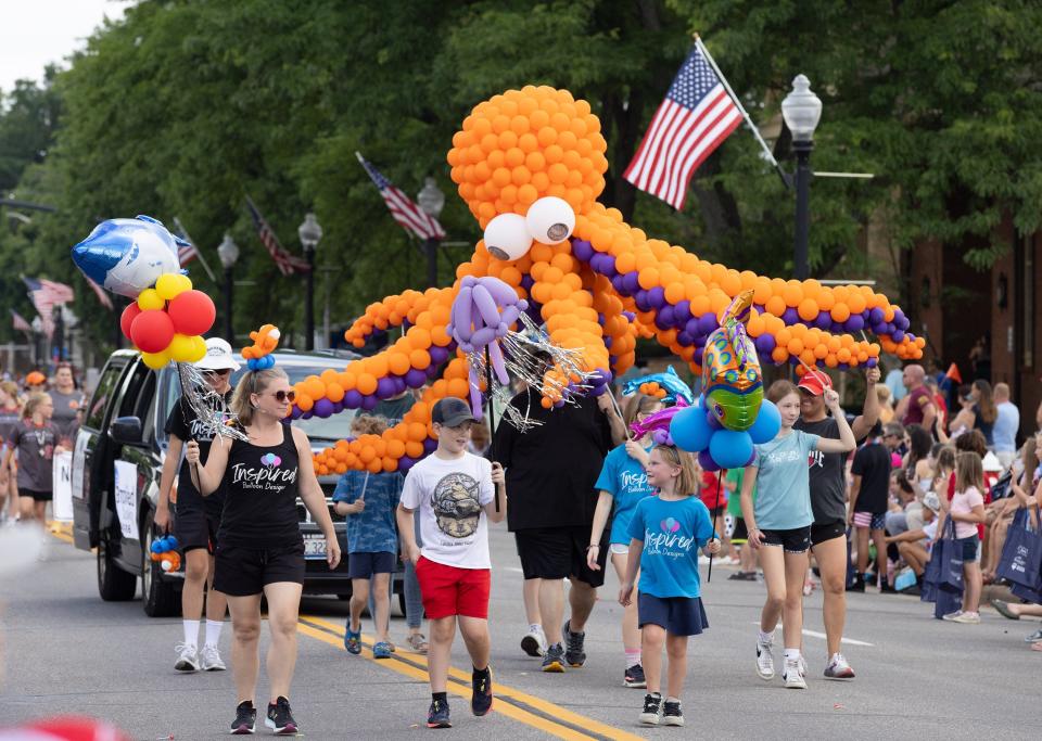 Inspired Balloon Design carries a creation Tuesday in the 52nd annual North Canton Fourth of July Parade.