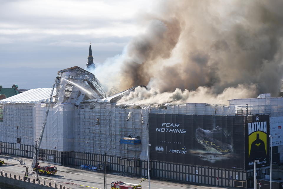 Smoke rise out of the Old Stock Exchange, Boersen, in Copenhagen, Denmark, Tuesday, April 16, 2024. One of Copenhagen’s oldest buildings is on fire and its iconic spire has collapsed. The roof of the 17th-century old Stock Exchange, or Boersen, that was once Denmark’s financial center, was engulfed in flames Tuesday. (Emil Helms/Ritzau Scanpix via AP)