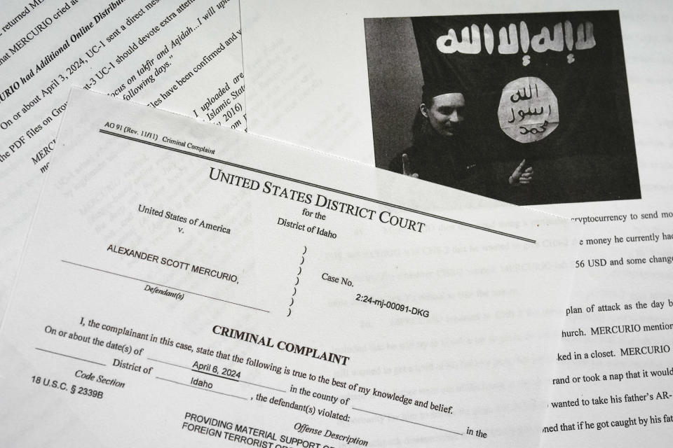 The criminal complaint against Alexander Scott Mercurio is photographed on Tuesday, April 9, 2024. Mercurio, 18, is charged with attempting to provide material support to the Islamic State group after prosecutors said he planned to carry out an attack on a Coeur d'Alene church. Mercurio was arrested Saturday, and the charges were unsealed in Idaho's U.S. District Court on Monday. (AP Photo/Jenny Kane)