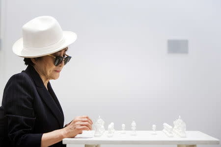 Artist Yoko Ono interacts with the exhibit "White Chess Set" at the Museum of Modern Art exhibition dedicated exclusively to her work, titled "Yoko Ono: One Woman Show, 1960-1971", in New York May 12, 2015. REUTERS/Lucas Jackson