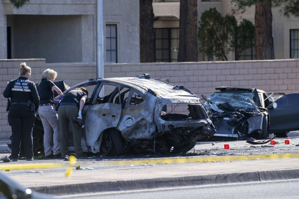 Las Vegas Metro Police investigators work at the scene of a fatal crash Tuesday, Nov. 2, 2021, in Las Vegas. Police in Las Vegas say Las Vegas Raiders wide receiver Henry Ruggs III was involved in the fiery vehicle crash early Tuesday that left a woman dead and Ruggs and his female passenger injured. / Credit: Eric Jamison / AP