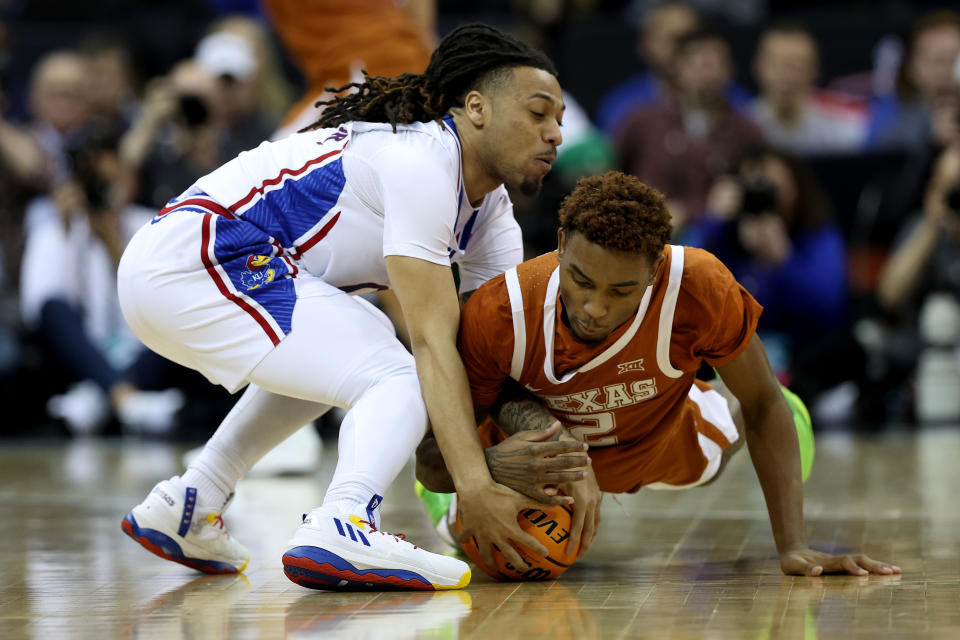 KANSAS CITY, MISSOURI - MARCH 11: Arterio Morris #2 of the Texas Longhorns dives for the ball against Bobby Pettiford Jr. #0 of the Kansas Jayhawks during second half of the Big 12 Tournament Championship game at T-Mobile Center on March 11, 2023 in Kansas City, Missouri. (Photo by Jamie Squire/Getty Images)