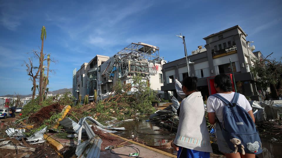 People look at damages caused by Hurricane Otis in Acapulco, Mexico. - Henry Romero/Reuters