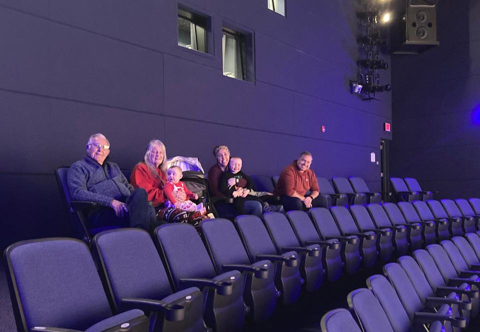 Waiting for the first showing of "Titans of the Ice Age" on Feb. 20 in the theater at the Tom Ridge Environmental Center, 301 Peninsula Drive, are, from left, family members Tom Lowes of North East; his wife, Sandy Lowes, holding great-granddaughter Finlay Hannay, 7 months; their granddaughter, Ashley Hannay of Atlanta, Georgia, holding son Gideon Hannay, 3; Valor Hannay, 4, partially hidden; and Zack Hannay.