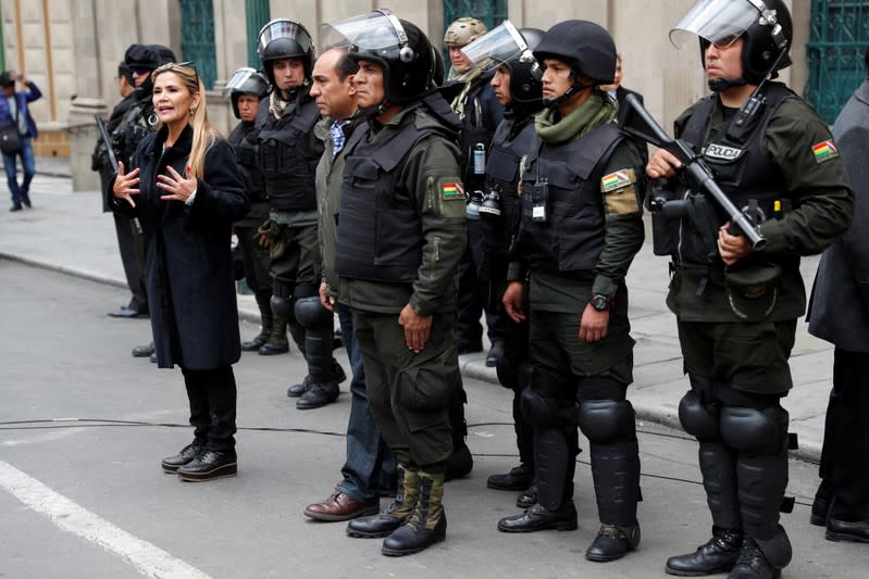 Bolivian Interim President Jeanine Anez takes part in a ceremony with the police in front of the Presidential Palace, in La Paz