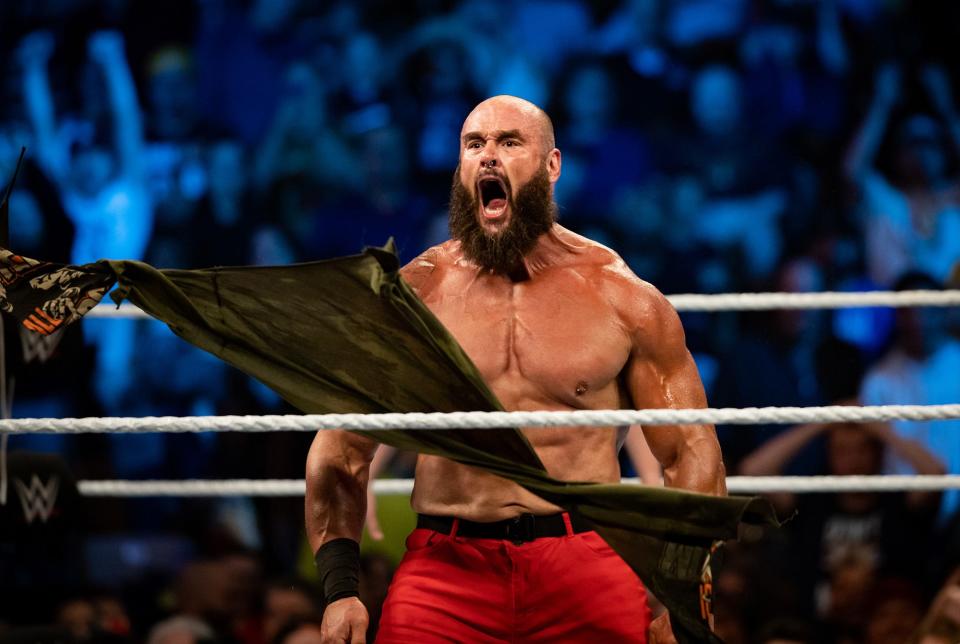 WWE star Braun Strowman tears off his shirt as he roars on during his entrance into the ring. Strowman will wear a pair of custom boots Friday and then auction them off to benefit those affected by the Waukesha Christmas Parade tragedy in 2021.