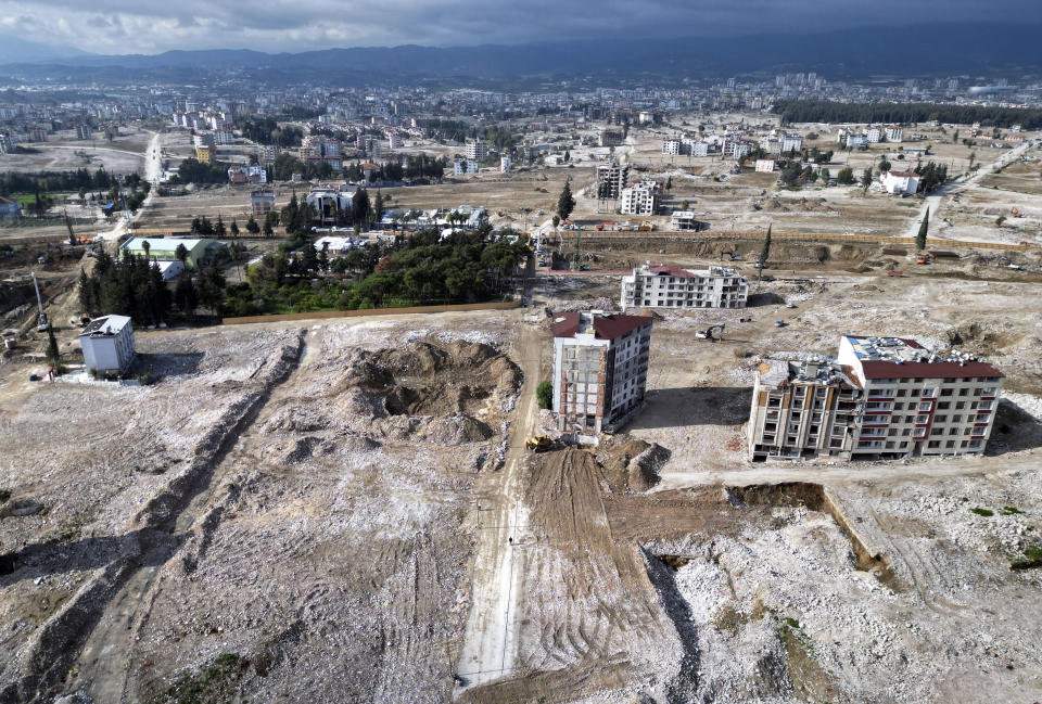 This Thursday, Jan. 11, 2024 photo shows an arial view of terrain that were cleared of rubble from buildings that were destroyed by the Feb. 6, 2023 powerful earthquake in the city of Antakya, southern Turkey. A year after the quake, many of the collapsed or seriously damaged buildings in hard-hit Antakya have been torn down and the debris removed. (AP Photo/Khalil Hamra)